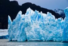 ice burg floating on water during daytime