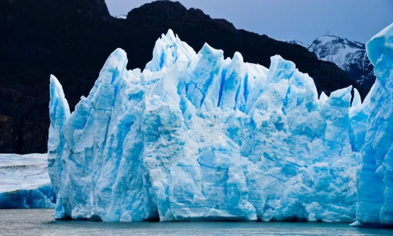 ice burg floating on water during daytime