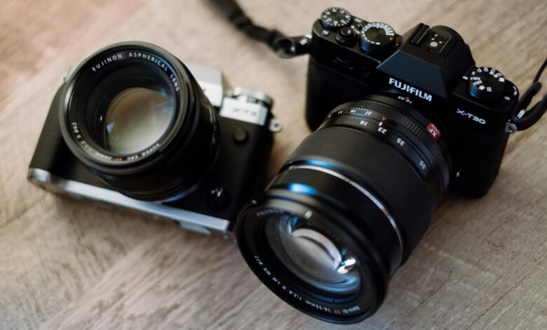 black and gray slr camera and black fujifilm dslr camera