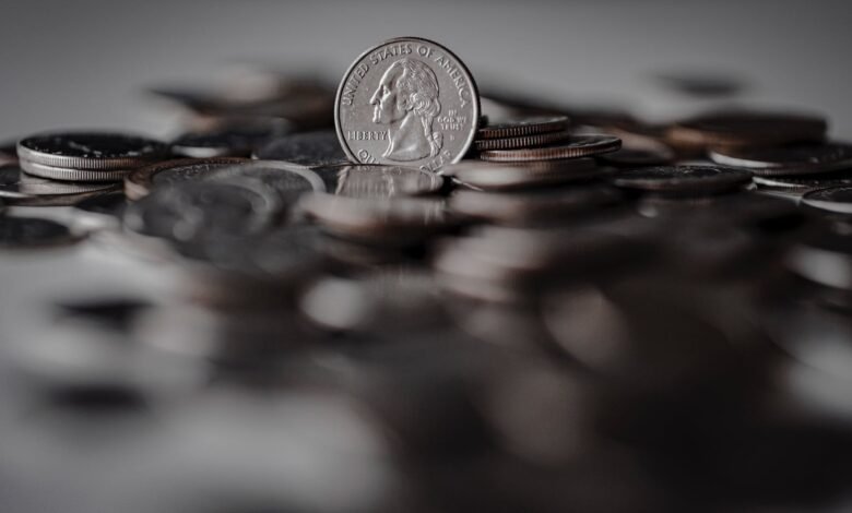 silver round coins on brown wooden surface