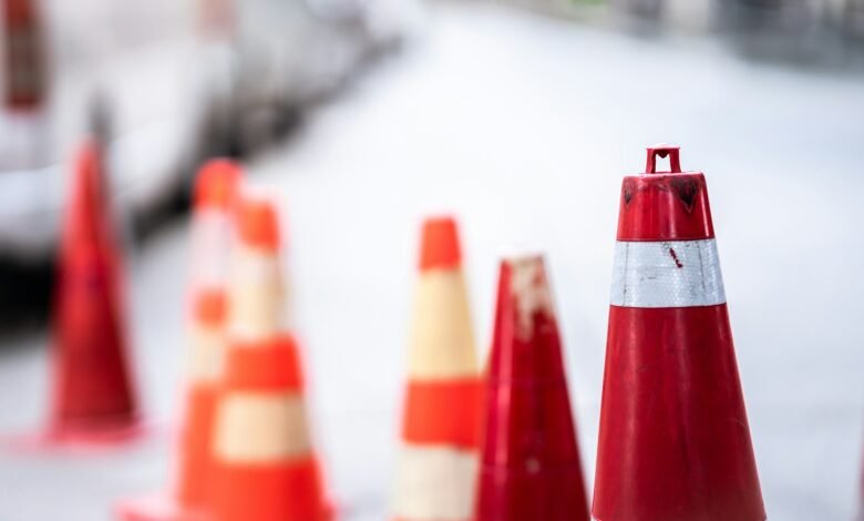 An orange traffic cone is placed on the road.