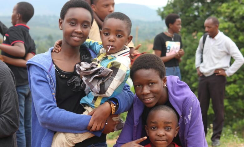 woman wearing blue jacket carrying a little boy