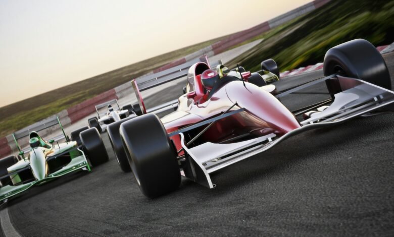 Red race car close up front view on a track leading the pack with motion Blur