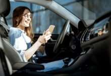 Woman with phone in the car